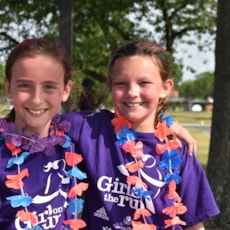 Two Girls on the Run participants smiling after completing 5k event.